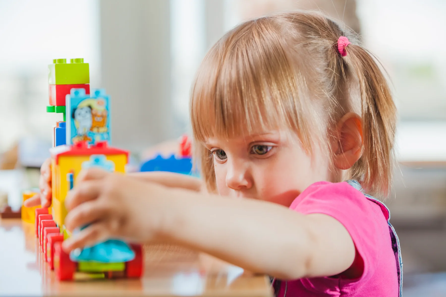 Adorable girl with a toy train
