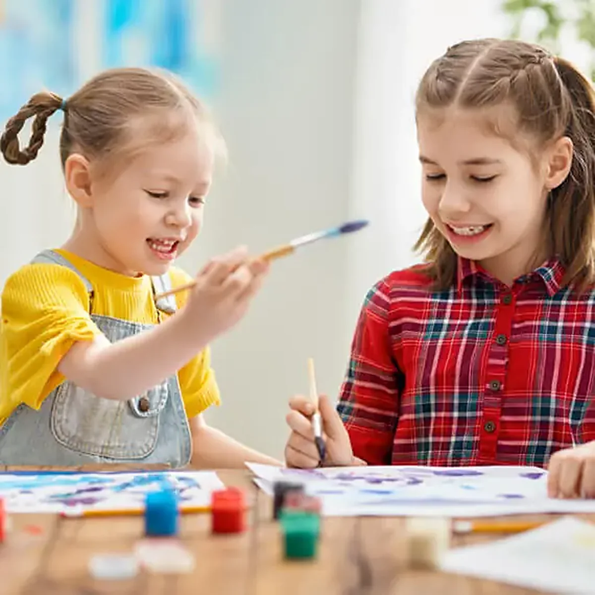 Kids painting together at the art table
